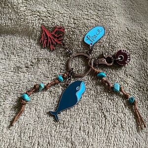 The Sak Roots Blue Whale Fish Keychain with Coral and Peace Charms